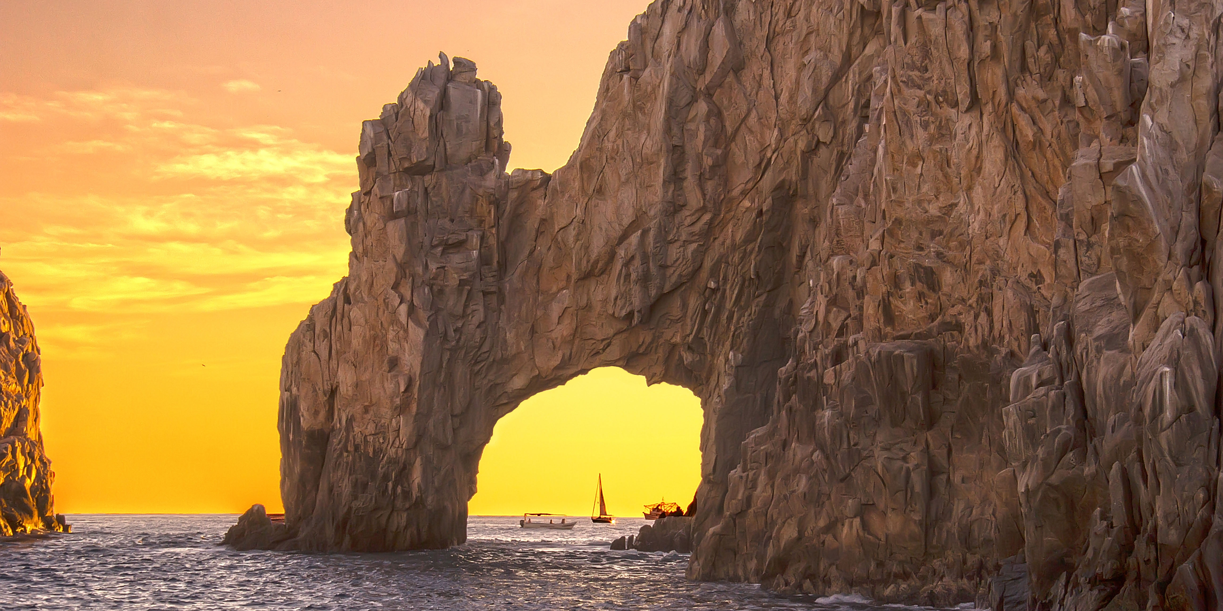 El Arco glowing gold at sunset